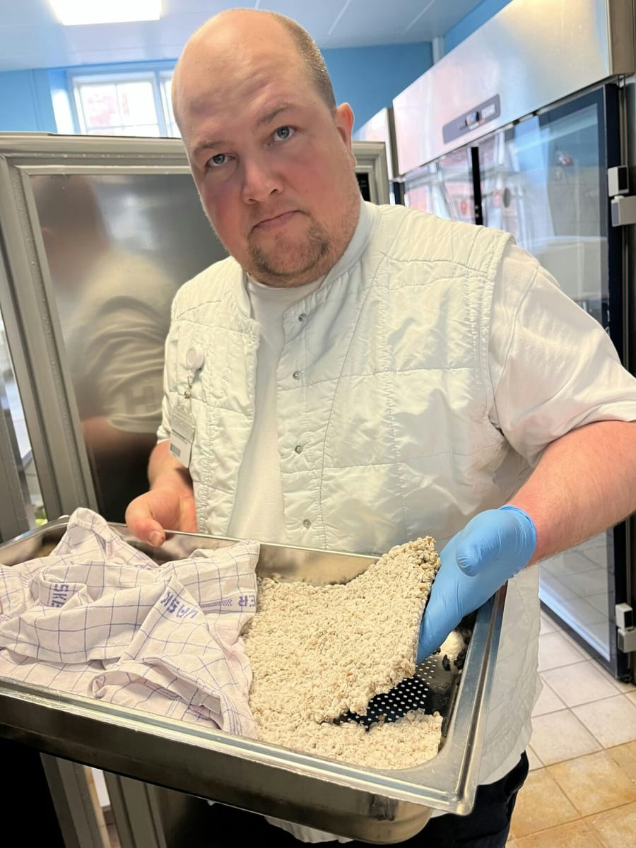 Philip Rosenquist, fermenteringsspecialist på Bispebjerg Hospital, viser byg, der er dækket af en svampekultur, frem. Svampene nedbryder noget af proteinet i byggen til aminosyrer, der skaber umamismag. Princippet er det samme som til produktionen af sojasovs. Foto: Ashis Gautam